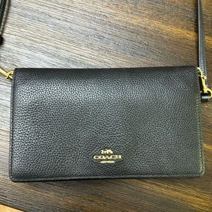 Cute small Coach purse. Has space for credit cards and more.
